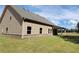 Back of the house with covered back porch and well-maintained lawn at 3828 Southfield Ct, Loganville, GA 30052