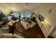 Open living space with hardwood floors, fireplace, and large windows, viewed from the staircase at 3828 Southfield Ct, Loganville, GA 30052