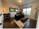 Bright home office with a dark wood desk, plush seating, and custom window treatments at 3828 Southfield Ct, Loganville, GA 30052