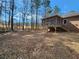 This home features a wooded backyard, a brick exterior and a screened-in porch at 770 Prickett Rd, Douglasville, GA 30134