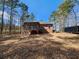 Expansive backyard featuring a screened porch and stairs leading down to a lower level patio at 770 Prickett Rd, Douglasville, GA 30134