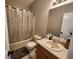 This bathroom includes a tub with shower, neutral colored walls and vanity with sink at 770 Prickett Rd, Douglasville, GA 30134