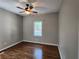 This bedroom includes hardwood floors, a ceiling fan and a window with wooded views at 770 Prickett Rd, Douglasville, GA 30134