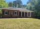 Charming brick home featuring a covered front porch and well-manicured lawn at 770 Prickett Rd, Douglasville, GA 30134