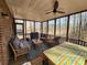 This screened-in porch offers an open-air seating area with views of the woods beyond at 770 Prickett Rd, Douglasville, GA 30134