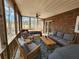 This screened-in porch features a seating area with a sofa, chairs, and a coffee table at 770 Prickett Rd, Douglasville, GA 30134