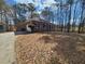 Brick home with a long driveway, garage, and wooded surroundings at 770 Prickett Rd, Douglasville, GA 30134