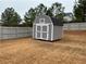 Backyard shed painted gray and white in a fenced-in yard at 140 Craines Vw, Covington, GA 30014