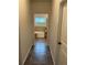 Bathroom hallway with tiled floors and a view of the bathtub and tiled walls at 140 Craines Vw, Covington, GA 30014