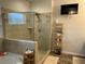 Bathroom with bathtub, glass shower, and shelving unit for decor at 140 Craines Vw, Covington, GA 30014