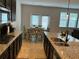 Bright kitchen featuring granite countertops, modern appliances, and an adjacent dining area with natural light at 140 Craines Vw, Covington, GA 30014