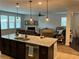 Open-concept kitchen with stainless steel appliances, a center island, and view into the cozy living space at 140 Craines Vw, Covington, GA 30014