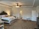 Large main bedroom features a king-size bed, and carpet floors at 140 Craines Vw, Covington, GA 30014