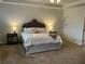 Stylish main bedroom with soft lighting, a king-size bed, and contemporary decor at 140 Craines Vw, Covington, GA 30014