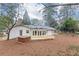 Backyard featuring a hot tub and wooden deck, surrounded by mature trees, offering a tranquil outdoor space at 2466 Sharondale Ne Dr, Atlanta, GA 30305