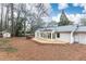 Backyard featuring a wooden deck and mature trees, creating a private outdoor retreat, with a storage shed at 2466 Sharondale Ne Dr, Atlanta, GA 30305