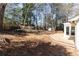 Expansive backyard features a wooden deck, storage shed, privacy fence, and mature trees at 2466 Sharondale Ne Dr, Atlanta, GA 30305