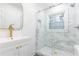 Modern bathroom with a glass-enclosed shower, vanity with gold fixtures, and natural light at 2466 Sharondale Ne Dr, Atlanta, GA 30305