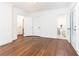 Bedroom featuring white trim, walls and door with wood flooring and view into bathroom at 2466 Sharondale Ne Dr, Atlanta, GA 30305