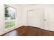 Bedroom featuring white trim, walls and door with wood flooring and bright window views at 2466 Sharondale Ne Dr, Atlanta, GA 30305