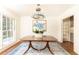 Bright dining room with a wood table, a stylish blue chandelier, and views to other rooms at 2466 Sharondale Ne Dr, Atlanta, GA 30305