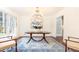 Elegant dining area featuring hardwood floors, a blue accent rug, and large windows at 2466 Sharondale Ne Dr, Atlanta, GA 30305