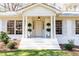 Inviting front entrance with stately columns, elegant lighting, and decorative greenery at 2466 Sharondale Ne Dr, Atlanta, GA 30305