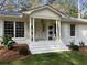 Elegant front entrance with classic columns, decorative statues, and fresh landscaping at 2466 Sharondale Ne Dr, Atlanta, GA 30305