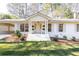 Charming exterior of painted brick home with a covered front porch and manicured lawn at 2466 Sharondale Ne Dr, Atlanta, GA 30305