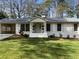 Attractive home featuring manicured landscaping, traditional shutters, and a welcoming porch at 2466 Sharondale Ne Dr, Atlanta, GA 30305