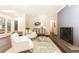 Bright living room featuring hardwood floors, fireplace, and white armchairs at 2466 Sharondale Ne Dr, Atlanta, GA 30305