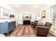 An inviting living room is showcased with hardwood floors and a cozy seating area with an eye-catching accent rug at 2466 Sharondale Ne Dr, Atlanta, GA 30305