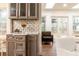 Wet bar area with modern cabinetry and stylish backsplash at 2466 Sharondale Ne Dr, Atlanta, GA 30305