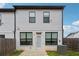 Back exterior of home featuring a white brick design and fenced in backyard at 43 N Auburn Landing Pl, Auburn, GA 30011