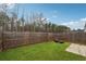 Spacious backyard with green grass and a wooden fence, perfect for outdoor enjoyment at 43 N Auburn Landing Pl, Auburn, GA 30011