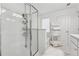 Bright white bathroom featuring a glass shower with shelving and decorative towel ladder at 43 N Auburn Landing Pl, Auburn, GA 30011