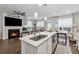 Bright kitchen features an island with quartz countertop, stainless steel appliances, and hardwood floors at 43 N Auburn Landing Pl, Auburn, GA 30011