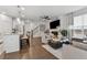 Cozy living room with kitchen, staircase, and fireplace at 43 N Auburn Landing Pl, Auburn, GA 30011