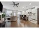 Open-concept living room and kitchen with hardwood floors and neutral decor at 43 N Auburn Landing Pl, Auburn, GA 30011