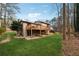 Expansive backyard featuring a large deck, a patio, and a well-maintained lawn at 9480 Hillside Dr, Roswell, GA 30076