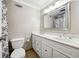 Bathroom featuring double sink vanity, updated fixtures, and a tiled floor at 9480 Hillside Dr, Roswell, GA 30076