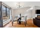 Stylish dining area with modern lighting, a glass table, and a view of the outdoors at 9480 Hillside Dr, Roswell, GA 30076