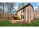 View of the deck and sliding glass door of this tan home with a large yard at 9480 Hillside Dr, Roswell, GA 30076