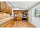 Functional kitchen with granite countertops, stainless steel appliances, and access to the deck at 9480 Hillside Dr, Roswell, GA 30076