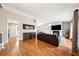 Bright living room featuring hardwood floors, a fireplace, and ample seating at 9480 Hillside Dr, Roswell, GA 30076