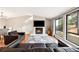 Bright living room featuring fireplace, windows, and hardwood flooring at 9480 Hillside Dr, Roswell, GA 30076