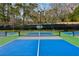 Colorful pickleball courts with manicured landscaping in a beautiful setting are ready for play at 9480 Hillside Dr, Roswell, GA 30076