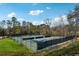 Aerial view of well-maintained pickleball courts, tennis courts, surrounded by lush landscaping at 9480 Hillside Dr, Roswell, GA 30076