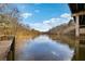 Scenic river view with clear water, framed by trees, captured from a wooden dock at 9480 Hillside Dr, Roswell, GA 30076