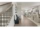 Hallway featuring modern stairs, hardwood floors, and an open view into the modern kitchen at 107 Holt Ln, Lawrenceville, GA 30046